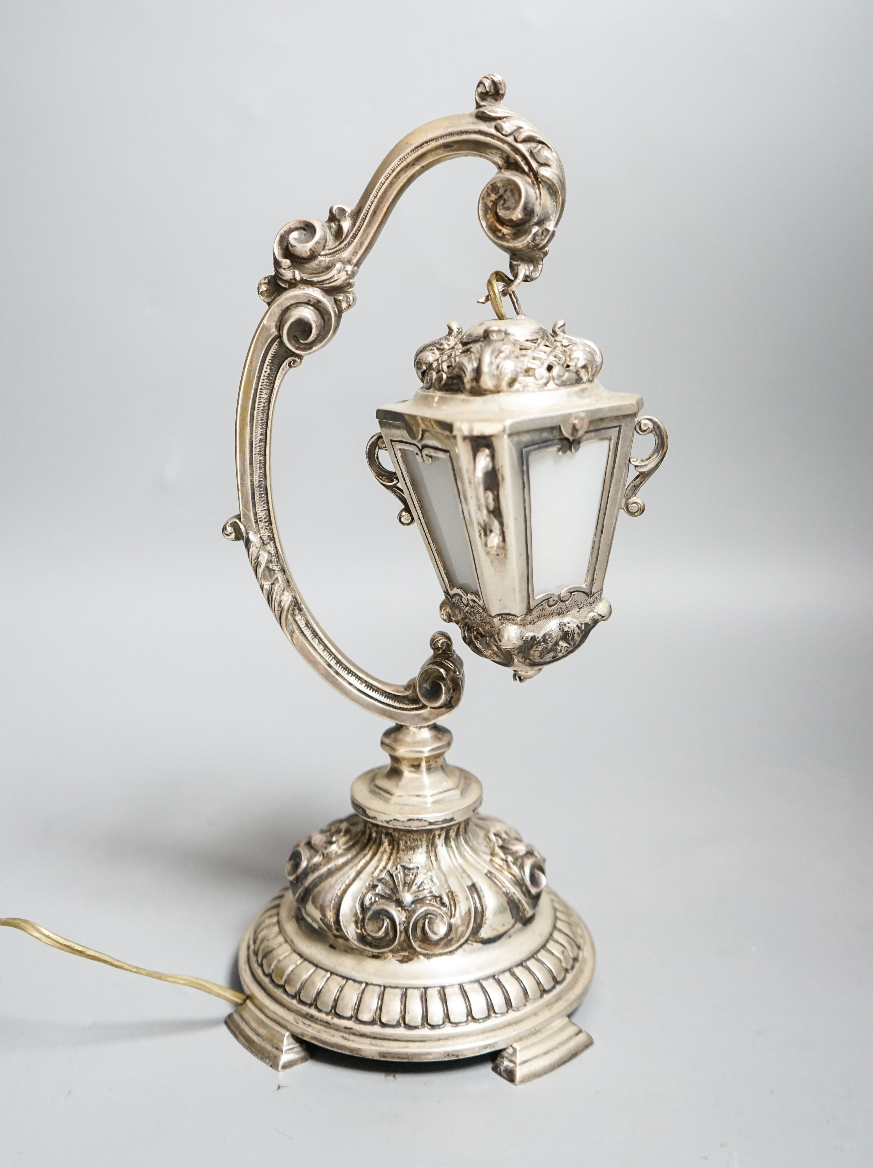 A Portuguese white metal table lamp modelled as a hanging lantern, height 28.1cm.
